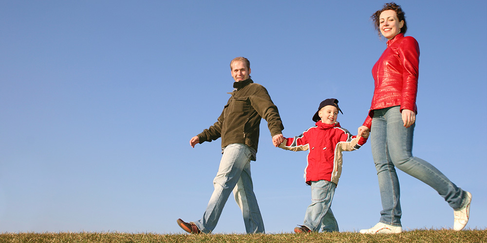 Parents walking with their child