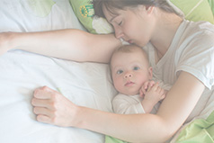 Mother resting with her child