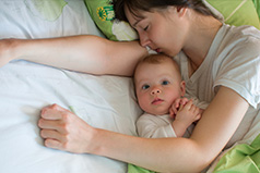 Mother resting with her child