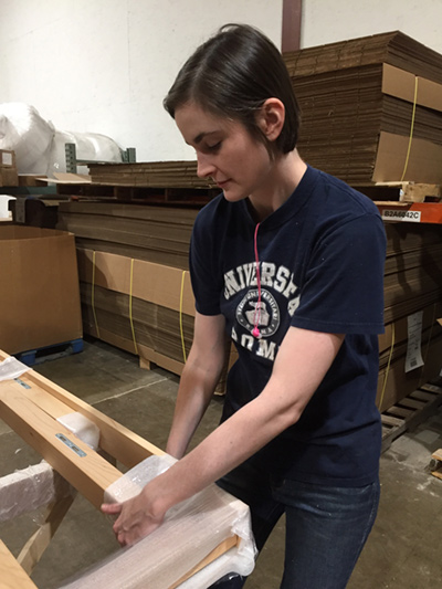 Leah packs a natural platform bed for shipment