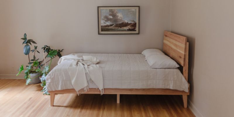 Sustainable wooden bed frame with adjustable base.