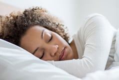 Black woman sleeping in bed