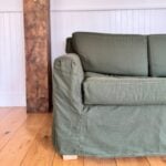Detail of Verona sofa arm and cushion under organic slipcover